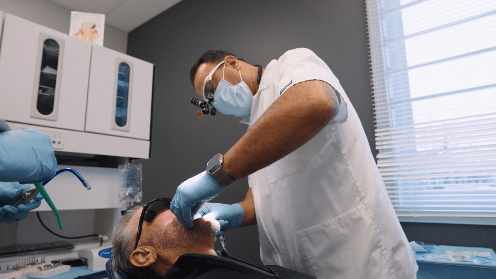 Dentist Dr Luka placing implant in london, on dental office